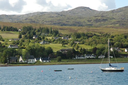 This photo shows the Old Manse as seen from Slumbay Island. It is the house to the left of the picture just back from the water's edge.